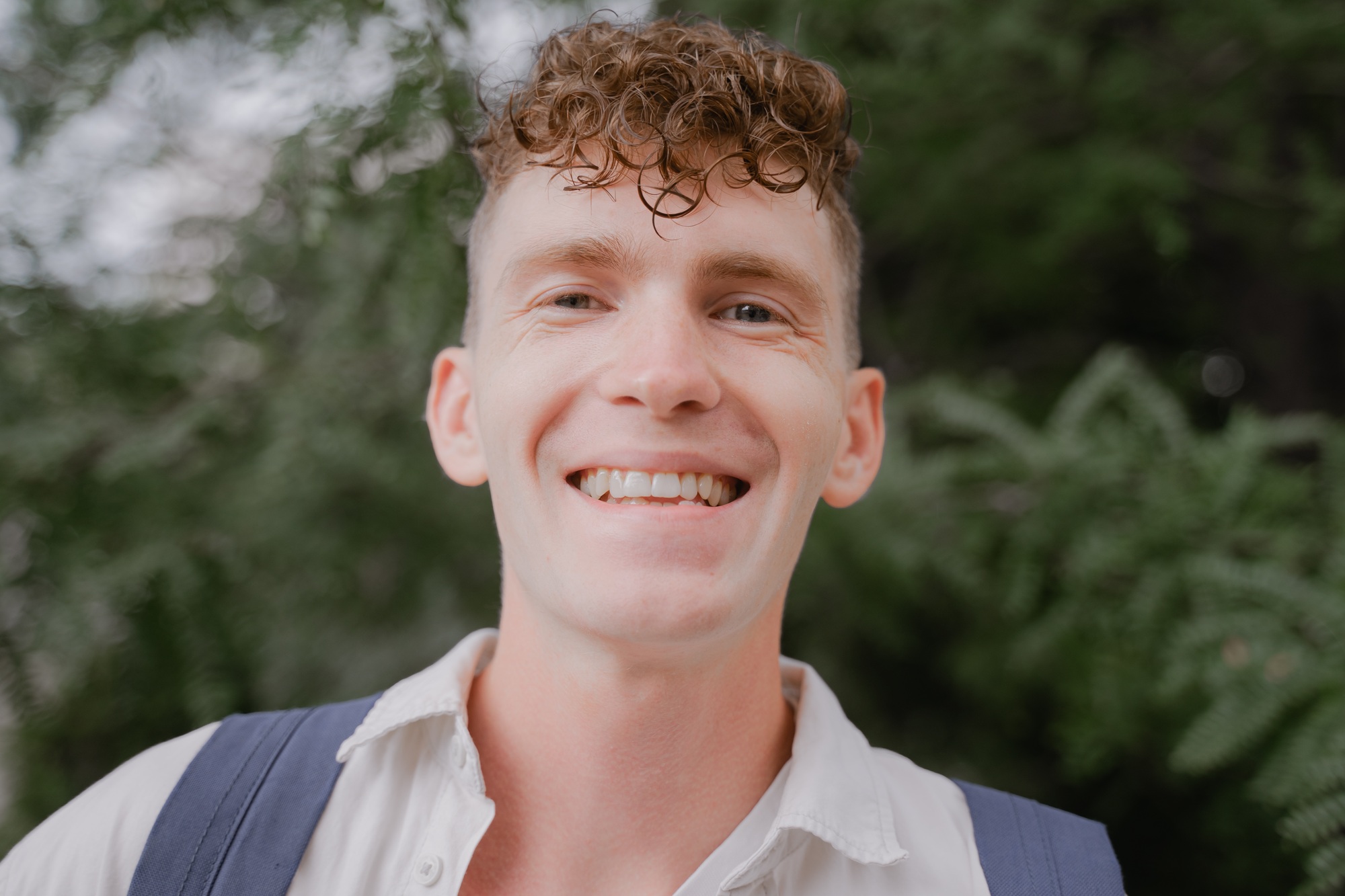 happy smiling portrait of guy with curly hair